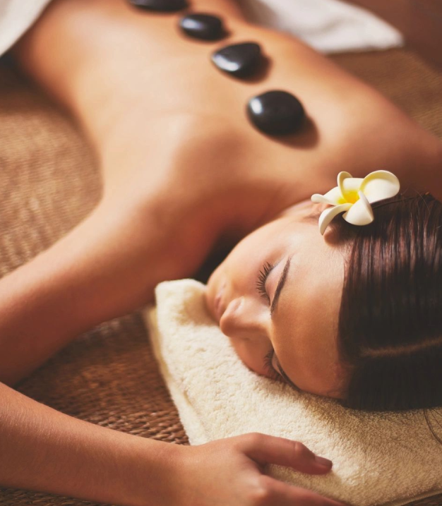 Woman relaxing with hot stone massage.