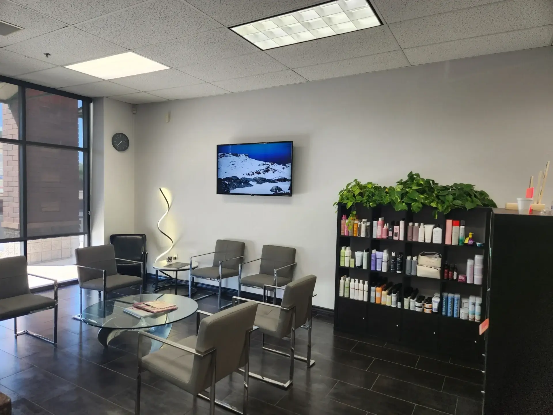Modern waiting room with chairs and shelves.